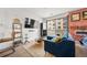 Living area showcases modern decor, a brick fireplace, and an open layout to the bedroom at 1898 S Bannock St # 202, Denver, CO 80223