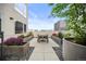 Charming patio with a dining table and garden planters, perfect for relaxing and entertaining at 1898 S Bannock St # 202, Denver, CO 80223