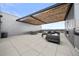 Expansive rooftop deck featuring modern lounge furniture, a dining table, and a sleek pergola at 1898 S Bannock St # 202, Denver, CO 80223