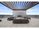 Spacious rooftop deck with comfortable seating areas and a modern outdoor fireplace at 1898 S Bannock St # 202, Denver, CO 80223