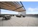 Inviting rooftop deck with stylish outdoor furniture and a cozy fireplace feature at 1898 S Bannock St # 202, Denver, CO 80223