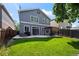 Well-maintained backyard with lush lawn, patio, and pergola perfect for outdoor entertaining and relaxation at 4975 S Zephyr St, Littleton, CO 80123