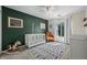 Charming Bedroom with an accent wall, rocking horse, comfortable chair, and great natural lighting at 4975 S Zephyr St, Littleton, CO 80123