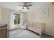 Calm and inviting Bedroom with crib, comfortable chair, soft rug, and ample natural light for a serene environment at 4975 S Zephyr St, Littleton, CO 80123