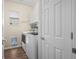 Convenient laundry room with modern washer and dryer, storage shelves, and bright natural light at 4975 S Zephyr St, Littleton, CO 80123