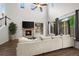 Bright living room with a fireplace, hardwood floors, ample natural light, and comfortable seating at 4975 S Zephyr St, Littleton, CO 80123