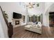 Bright living room boasting a fireplace, ceiling fan, large windows, and comfortable seating at 4975 S Zephyr St, Littleton, CO 80123