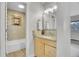 Updated bathroom featuring a stylish vanity and a tub/shower combo with decorative tile at 5995 E Iliff Ave # 308, Denver, CO 80222