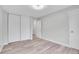 A bright, empty bedroom features wood-look flooring and large closets, perfect for ample storage at 5995 E Iliff Ave # 308, Denver, CO 80222