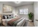 Bright bedroom featuring a neutral color palette, contemporary art, and light wood-look flooring at 5995 E Iliff Ave # 308, Denver, CO 80222
