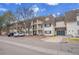 Attractive condo building with brick facade, balconies, and ample parking in a well-maintained community at 5995 E Iliff Ave # 308, Denver, CO 80222