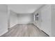 Spacious living room featuring new laminate flooring, fresh paint, and natural light from the large window at 5995 E Iliff Ave # 308, Denver, CO 80222