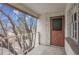 A covered patio features a view of the community and a unique door at 5995 E Iliff Ave # 308, Denver, CO 80222