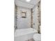 The bathtub/shower combo includes decorative tile and a built-in niche at 5995 E Iliff Ave # 308, Denver, CO 80222