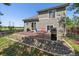 A backyard patio features a red brick surface with an outdoor dining set and gas grill at 19688 E Lasalle Dr, Aurora, CO 80013