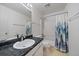 This bathroom features a vanity with countertop, toilet, and shower with curtain, offering essential functionality at 19688 E Lasalle Dr, Aurora, CO 80013