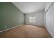 This bedroom features neutral carpet, two-tone walls, and a window for natural light, with a double closet for storage at 19688 E Lasalle Dr, Aurora, CO 80013
