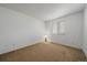 This bedroom features neutral carpet, white walls, and a window for natural light, offering a simple and functional space at 19688 E Lasalle Dr, Aurora, CO 80013