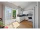 Well-lit kitchen with white cabinets, stainless steel appliances, and a sliding glass door at 19688 E Lasalle Dr, Aurora, CO 80013