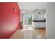 Open kitchen and dining area with a red accent wall and sliding glass door to the backyard at 19688 E Lasalle Dr, Aurora, CO 80013