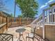 Back patio featuring a wrought iron table with two chairs, stone pavers and a wood fence at 4418 W 11Th Ave, Denver, CO 80204