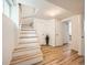 Finished basement area with light wood floors, a staircase, and white walls at 4418 W 11Th Ave, Denver, CO 80204