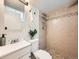 Bathroom showcasing a tiled shower, modern fixtures, vanity, and neutral finishes at 4418 W 11Th Ave, Denver, CO 80204