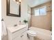 Bathroom featuring a tiled shower-tub combo, decorative tile accents, and a vanity at 4418 W 11Th Ave, Denver, CO 80204
