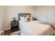 Comfortable bedroom featuring a well-made bed with neutral decor, a side table, and a closet door at 4418 W 11Th Ave, Denver, CO 80204