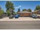 Single story red brick home with off street parking for four cars on concrete pad at 4418 W 11Th Ave, Denver, CO 80204