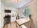 Bright kitchen with white cabinets, stainless steel appliances, and a convenient breakfast bar at 4418 W 11Th Ave, Denver, CO 80204