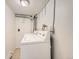Laundry area with appliances, tiled floor, and utilitarian design at 4418 W 11Th Ave, Denver, CO 80204