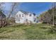 Fenced backyard with a lush lawn, mature trees, and an outdoor dining area at 9456 Bexley Dr, Highlands Ranch, CO 80126