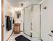Cozy bathroom featuring a vanity, shower with glass door, and patterned tile flooring at 9456 Bexley Dr, Highlands Ranch, CO 80126