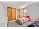 Comfortable bedroom with ample closet space, a cozy window seat and neutral paint at 9456 Bexley Dr, Highlands Ranch, CO 80126