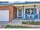 Close-up of the home's inviting front porch with blue railings and well-kept landscaping details at 9456 Bexley Dr, Highlands Ranch, CO 80126