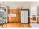 Well-lit kitchen with hardwood floors, light wood cabinetry and breakfast nook at 9456 Bexley Dr, Highlands Ranch, CO 80126