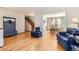 Open-concept living area with hardwood floors, seamlessly connecting to the dining area and staircase at 9456 Bexley Dr, Highlands Ranch, CO 80126