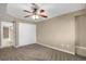 Spacious carpeted bedroom with ceiling fan and double doors at 21787 Unbridled Ave, Parker, CO 80138