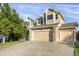 Two-story house with beige siding, stone accents, and a two-car garage at 21787 Unbridled Ave, Parker, CO 80138