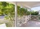 White wooden front porch railing and view of landscaping at 21787 Unbridled Ave, Parker, CO 80138