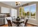 Kitchen nook with a charming round table and backyard views at 21787 Unbridled Ave, Parker, CO 80138