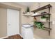 Convenient laundry room with shelving and a utility sink at 21787 Unbridled Ave, Parker, CO 80138