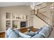 Living room with hardwood floors, fireplace and staircase at 21787 Unbridled Ave, Parker, CO 80138