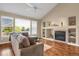 Spacious living room with a fireplace, hardwood floors, and large windows at 21787 Unbridled Ave, Parker, CO 80138