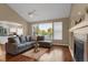 Living room with hardwood floors, fireplace and view into kitchen at 21787 Unbridled Ave, Parker, CO 80138