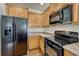 Kitchen boasts black appliances and ample wood cabinetry at 750 Vista Verde Hts, Monument, CO 80132