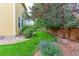Backyard featuring luscious grass and mature trees around the edge of the property at 2631 E 136Th Pl, Thornton, CO 80602