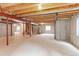 Unfinished basement with visible ceiling structure, cement walls, and natural light from windows at 2631 E 136Th Pl, Thornton, CO 80602