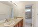 Well-lit bathroom featuring a double vanity and a view into the shower and toilet area at 2631 E 136Th Pl, Thornton, CO 80602